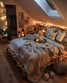 an attic bedroom is decorated with lights and blankets