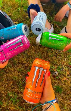 several people are holding water bottles in the grass