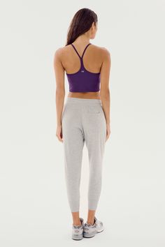 Our best-selling classic cropped sweatpant in ultra luxe fleece, Reena will become your go to piece for every day wear. Pair it with the Warm Up Fleece Pullover and enjoy effortless fit and pure comfort. BEST FOR: Chilling out after running, yoga, CrossFit, barre, Pilates, cycling and spin class. Model Stats:Height: 5’10”, Bust: 32", Waist: 23”, Hips: 34”Wearing size: Small Stretch Sweats For Lounging In Athleisure Style, Sporty Yoga Pants For Lounging, Solid Color Athleisure Activewear For Lounging, Solid Cropped Pants For Loungewear, Cropped Relaxed Fit Sweats For Athleisure, Solid Cropped Loungewear Pants, Lounging Sportswear With Elastic Waistband, Ribbed Waistband Yoga Pants For Lounging, Athleisure Pants For Lounging