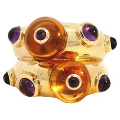 This magnificent citrine and amethyst ring is a one-of-a-kind piece of artisanal jewelry that would make a treasured addition to any fine accessories collection. Crafted from 18-karat yellow gold, it features two expertly cut citrine beads. Nestled between each bead is a subtly placed Cabochon Amethyst accent that enhances the luminous golden glow of the citrines. The mix of natural gemstones creates a beautifully balanced design full of depth, light, and surprise around each turn. Wearing this Luxury Citrine Cabochon Jewelry, Luxury Amethyst Cabochon Ring, Gold Luxury Amethyst Multi-stone Ring, Luxury Gold Amethyst Multi-stone Ring, Luxury Gold Multi-stone Amethyst Ring, Yellow Gold Amethyst Cabochon Gemstones, Unique Yellow Gold Amethyst Ring, Unique Multi-stone Gold Amethyst Ring, Unique Gold Multi-stone Amethyst Ring