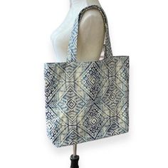 Large blue diamond Moroccan tote bag with lining and pockets inside. Boxed out flat bottom. Padded shoulder straps. 100% handcrafted in PA. Great to use as a purse or as a shopping bag. 100% cotton canvas outside with midweight fusible interfacing throughout bag. 100% cotton muslin lining. Dimensions are: 15" H, 14.75" W, 4" D. Large Blue Canvas Bag, Large Blue Canvas Bag For Everyday Use, Blue Square Canvas Travel Bag, Artisan Blue Tote Bag, Blue Square Reversible Bag, Artisan Blue Bag For Market, Artisan Blue Bags For Market, Handmade Blue Canvas Travel Bag, Blue Reversible Rectangular Bag