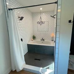 a bath room with a tub a sink and a mirror on the wall in it