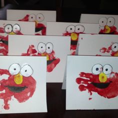 handprints made to look like elmo's face and hands with googly eyes