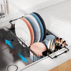 the dish rack is filled with plates and silverware