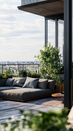 a couch sitting on top of a wooden floor next to a plant filled roof terrace