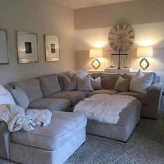 a living room filled with lots of furniture next to a large clock on the wall