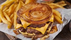 a cheeseburger with onion rings and fries on the side