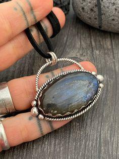 Powerful Sterling silver pendant with a big Labradorite stone. Made with unique details around it. A unique design that will make this pendant perfect for any occasion and for any outfit. The pendant comes with a black string chain, the one shown in the pictures, but you can use any chain that you already have. The pendant is 2.5cm- 1 inch long 4.4cm- 1.75 inch wide A unique addition to your jewelry collection. Enjoy Con salud! Unique Labradorite Pendant Jewelry, Handmade Labradorite Oval Pendant Necklace, Labradorite Large Round Pendant Jewelry, Labradorite Necklace With Large Round Stone Pendant, Labradorite Necklace With Large Round Pendant, Handmade Oval Labradorite Necklace, Artisan Oval Labradorite Necklace, Unique Oval Labradorite Necklace, Handmade Labradorite Oval Pendant Jewelry