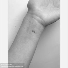 a person's arm with a small tattoo on the left side of their wrist