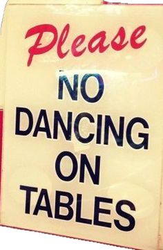 a sign that says please no dancing on tables