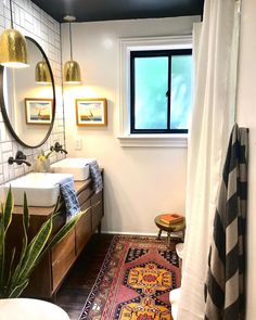 a bathroom with a rug, sink and mirror