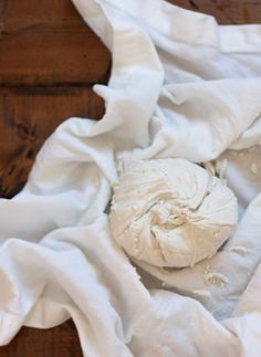 a piece of white cloth sitting on top of a wooden floor