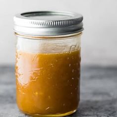 a glass jar filled with liquid sitting on top of a table