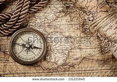 an old map with a compass and rope