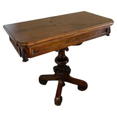 an old wooden table with one drawer on the top