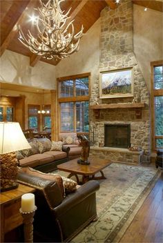 a living room with couches, chairs and a fireplace