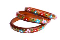 "A rich brown bangle that will add fun floral personality to your outfits featuring a row of hand-painted flowers in vibrant colors and delicate green leaves! In the center of every pink flower, a rhinestone adds the tiniest bit of sparkle! Choose a single bangle or buy a set of two or three to stack them and make a statement!  Wood Bangle, Inner Diameter 2 1/2\", 3/8\" wide                         SPECIAL SHIPPING RATES!!                         FREE US SHIPPING(certain items excluded) Single Bangle, Luo Binghe, Painting Candle Holders, Boho Elephant, Skull Pendant Necklace, Whimsical Jewelry, Painted Jewelry, Hand Painted Jewelry, Painted Flower