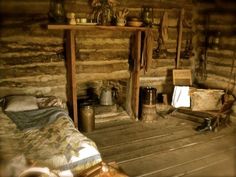 an old log cabin with wood floors and walls