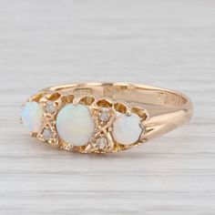 Gemstone Information: - Natural Opals - Size - 3.7, 4, 5 mm  Cut - Round Cabochon Color - Multicolor - Natural Diamonds - Total Carats - 0.02ctw Cut - Rose Metal: 18k Yellow Gold (XRF tested) Weight: 2.8 Grams  Stamps: Worn British Hallmarks Face Height: 7 mm  Rise Above Finger: 3.2 mm Band / Shank Width: 2.5 mm This ring is a size 8, but it can be resized down 2 sizes for a $25 fee or up 3 sizes for a $60 fee. If you would like your ring resized, please select the appropriate fee from the listi Mens Custom Jewelry, 3 Stone Rings, Silver Flatware, Rise Above, Ring Pictures, Ancient Artifacts, Vintage Designer, Natural Opal, Stone Ring