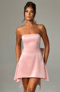 The Freja mini blush dress is party perfection. Crafted in luxurious stretch satin, this beautiful design is strapless with a corseted bodice and flirty, flouncy skirt. A dramatic bow to the back finishes the look. Homecoming Dresses Corset, Strapless Corset, Maxi Dress Sale, Popular Dresses, Sparkle Dress, Blush Dresses, Dresses By Length, Hoco Dresses, Stretch Satin