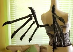 a mannequin with multiple arms and claws attached to it