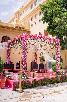 an outdoor wedding setup with pink flowers and greenery