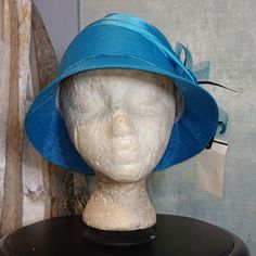 An Aquamarine Bucket Hat Accentuated With A Flower Bow And Black Feathers 100%Polyester Nwt Size:Os Blue Spring Bucket Hat With Short Brim, Blue Brimmed Cloche Hat For Beach, Blue Mini Hat For Beach, Spring Blue Bucket Hat With Short Brim, Blue Brimmed Cloche Hat For The Beach, Fitted Blue Sun Hat For Spring, Blue Wide Brim Cloche Hat For Beach, Blue Wide Brim Cloche Hat For The Beach, Blue Wide Brim Cloche Hat For Spring