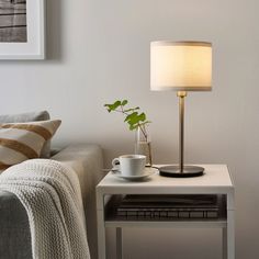 a living room with a couch, coffee table and lamp on it's side