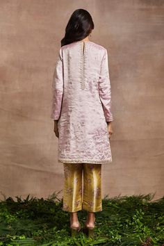 Pink handwoven silk tissue short kurta with silk thread, dori, sequins and patchwork hand embroidery. Comes with banarasi brocade trouser.
Components: 2
Pattern: Hand embroidered
Type Of Work: Thread, Dori, Sequins, Patchwork
Neckline: Round
Sleeve Type: Full
Fabric: Kurta : Handwoven silk tissue, Trouser : Banarasi brocade
Color: Pink
Other Details: 
Side pockets on kurta
Occasion: Mehendi and Haldi - Aza Fashions Banarasi Brocade, Pink Kurta, Short Kurta, Types Of Work, Silk Thread, Set For Women, Aza Fashion, Sleeve Type, Hand Embroidered