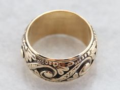 Crafted by the Art Carved company in the mid-1900s, this vintage yellow gold band features an ornate pattern of swirls, dots, and botanical motifs in a comfortable width. This will look nice all on its own, stacked with other bands or up against a vintage style engagement ring! Metal: 14K Yellow Gold Width of Band: 10.2 mm Height off Finger: 2.4 mm Ring Size: 7.50 Marks: "14K{ARTCARVED" Stamped on the inside band Mens Gold Ring Vintage, Ornate Pattern, Botanical Motifs, Vintage Style Engagement Rings, Vintage Jewellery Rings, Band Art, Mens Gold Rings, Swirl Ring, Stacking Bands