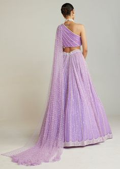 Lilac pearl embellished lehenga paired with one shoulder blouse with pearl cheetha trail. One Shoulder Sequin Evening Sets, One Shoulder Fitted Saree, One Shoulder Sequin Set For Party, Embellished One-shoulder Evening Saree, One-shoulder Sequin Set For Party, Evening One Shoulder Embellished Pre-draped Saree, Evening One-shoulder Embellished Pre-draped Saree, Festive One Shoulder Set With Sheer Dupatta, Bollywood Style One-shoulder Fitted Pre-draped Saree