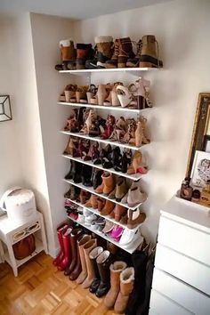 a white shelf filled with lots of pairs of shoes