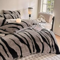 a zebra print comforter set on a bed