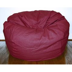 a red bean bag chair sitting on top of a white floor