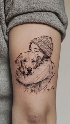 a woman with a dog tattoo on her thigh, holding it's head in her arms