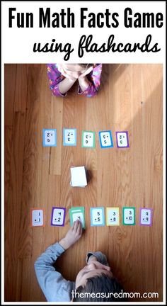 a young child is playing with the words fun math fact game using flashcards on the floor