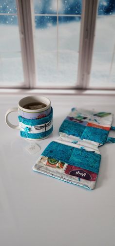 two coffee mugs sitting next to each other on top of a white countertop