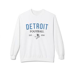 This Detroit Football Crewneck is a stylish and comfortable way to show your support for your favorite football team! Whether you're heading to the game or just lounging at home, this crewneck is sure to keep you warm and looking great. .: 80% Ringspun cotton, 20% Polyester (fiber content may vary for different colors) .: Medium-heavy fabric (8.4 oz/yd² (285 g/m .: Classic fit .: Tear-away label Sports Season Team Logo Crew Neck Sweatshirt, Sports Season Crew Neck Sweatshirt With Team Logo, Team-colored Crew Neck Sweatshirt With Team Logo, Sporty Football Season Sweatshirt With Team Name, White Fleece Top For Game Day, Football Season Team Logo Crew Neck Sweatshirt, Football Season Crew Neck Sweatshirt With Team Logo, Varsity Style Football Season Sweatshirt, Team-colored Crew Neck Sweatshirt For Team Spirit