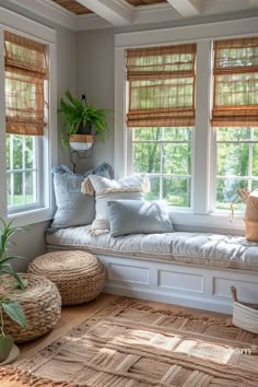 a window seat with pillows and plants on it in a room that has white walls