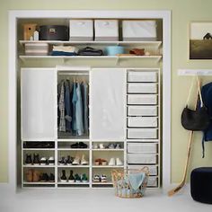 an organized closet with shoes, clothes and other items on shelves next to a chair