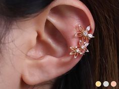 Available in 3 colours ✦ 18k gold plated ✦ Rhodium plated ✦ 18k rose gold plated Quality & Detail ✦ Ear cuff : Your ears don't have to be pierced to wear this product. ✦ Fits any ear as it is adjustable. ✦ The height 21.7mm ✦ The width 12.5mm ✦ Cubic zirconia Flower size 11.5mm ✦ Sold individually : Comes in a cute little package ready for gifting Shipping from United Kingdom Rose Gold Plated Cartilage Earrings, Rose Gold Pierced Ear Cuff As Gift, Dainty Yellow Gold Ear Cuff For Wedding, Delicate Gold Cartilage Earrings For Wedding, Dainty Gold Ear Cuff For Wedding, Delicate Wedding Cartilage Earrings, Dainty Rose Gold Cartilage Earrings For Wedding, Rose Gold Single Cartilage Earring For Wedding, Rose Gold Cubic Zirconia Cartilage Earrings As Gift