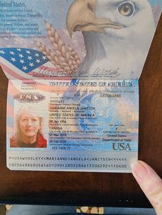 a person holding up an id card with an eagle on it