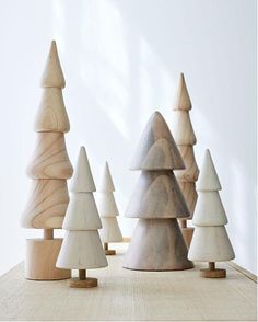 small wooden trees are lined up on a table