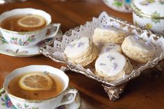 tea and cookies on a table with lemon slices