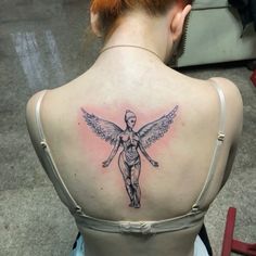 a woman with a tattoo on her back