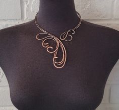 Handcrafted antique copper open necklace with bare copper wire. Hammered, tarnished, polished, and covered with a clear coating to protect the necklace from future discoloration.  If you need to clean your copper jewelry, please clean it by using warm water, and soap. Simply rub the mixture lightly and rinse with clean water and dry with a soft cloth.  Only one available. The pictured jewelry item in this listing is the actual piece you will receive. There are no Photoshop enhancements.  Thank you very much for looking! Happy shopping! Adjustable Bronze Copper Necklace, Unique Rose Gold Metal Necklace, Artistic Copper Jewelry With Soldered Details, Artistic Brown Copper Jewelry, Adjustable Hand Forged Copper Necklace, Hand Forged Copper Wire Necklace With Adjustable Fit, Hand Forged Rose Gold Copper Necklace, Hand Forged Copper Necklace In Rose Gold, Artistic Bronze Jewelry Made Of Copper