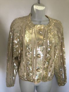 VTG 80's "Destinee" Cardigan Sequin Long Sleeve ivory Wool Acrylic Blend Sweater. Irridescent sequins. Snap front and covered buttons with sequins. Tag says small but seems larger. Check measurements. Chic Gold Cardigan For Winter, Gold Cardigan For Winter Party, Gold Cardigan For Fall Party, Cream Formal Cardigan For Fall, Formal Cream Cardigan For Fall, Elegant Gold Sweater For Winter, Elegant Gold Winter Sweater, Cream Formal Cardigan For Winter, Elegant Gold Cardigan For Winter