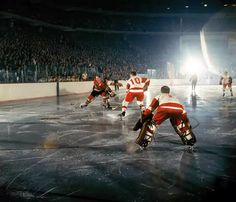 hockey players in red and white uniforms on the ice