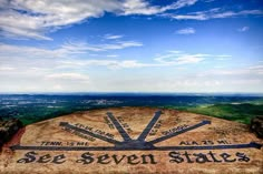 a sign on top of a hill that says see seven states