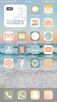 an iphone screen with icons on it, including the beach and ocean in the background